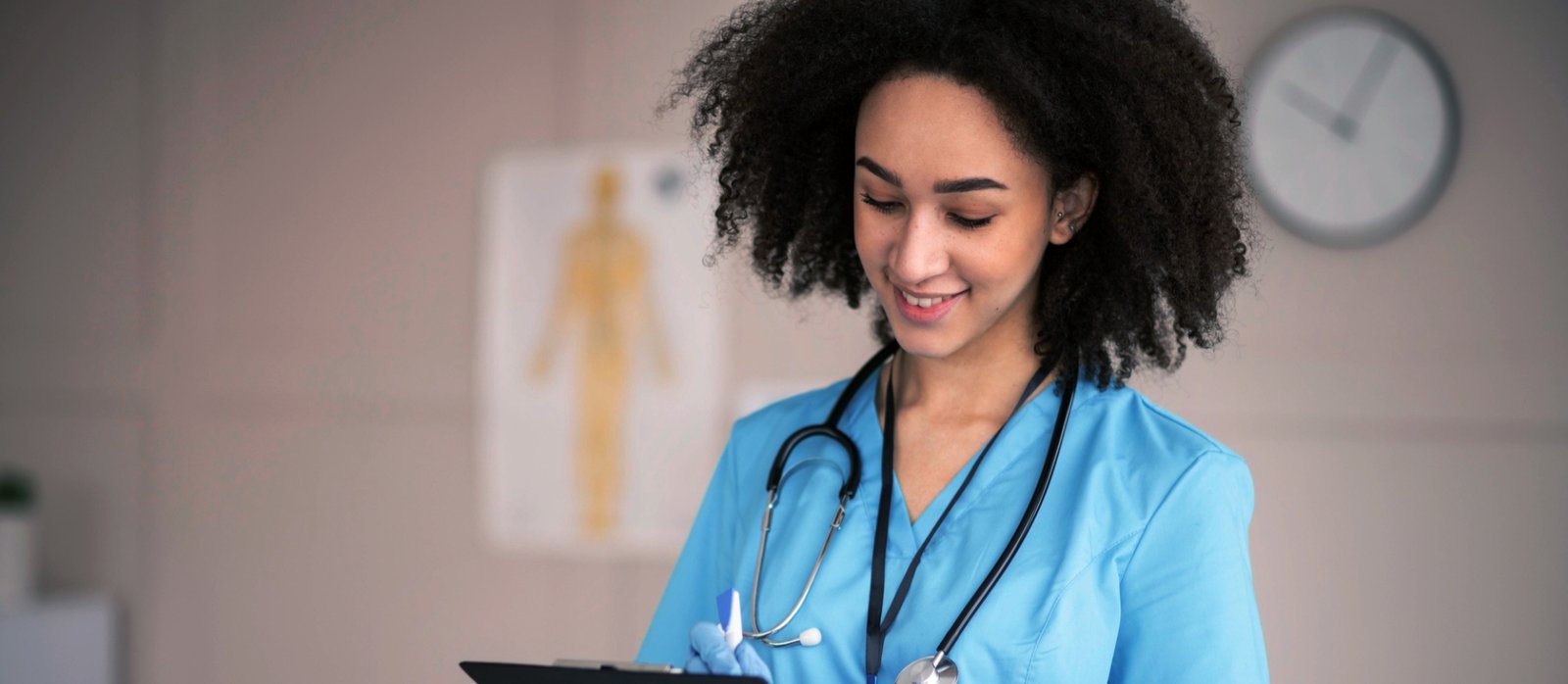 elder woman holding a tablet with caregiver