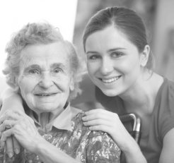 caregiver hugging elder woman