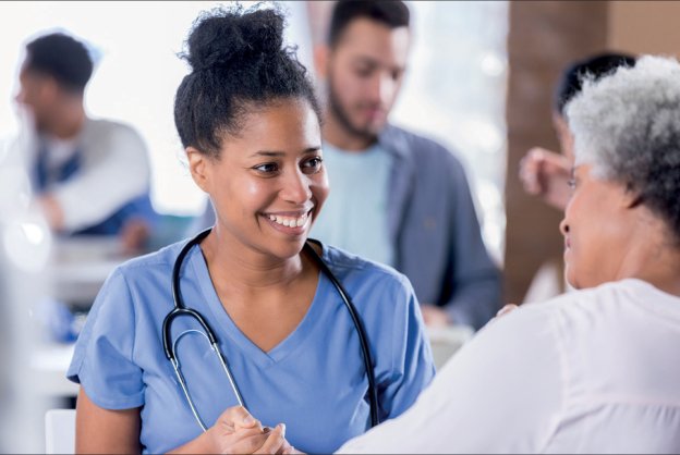elder man with caregiver drinking tea